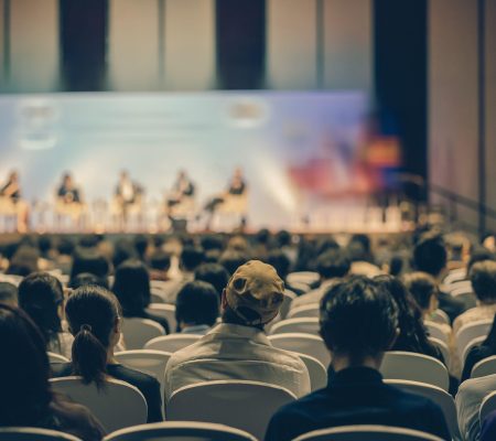 Rear view of Audience listening Speakers on the stage in the conference hall or seminar meeting, business and education about investment concept
